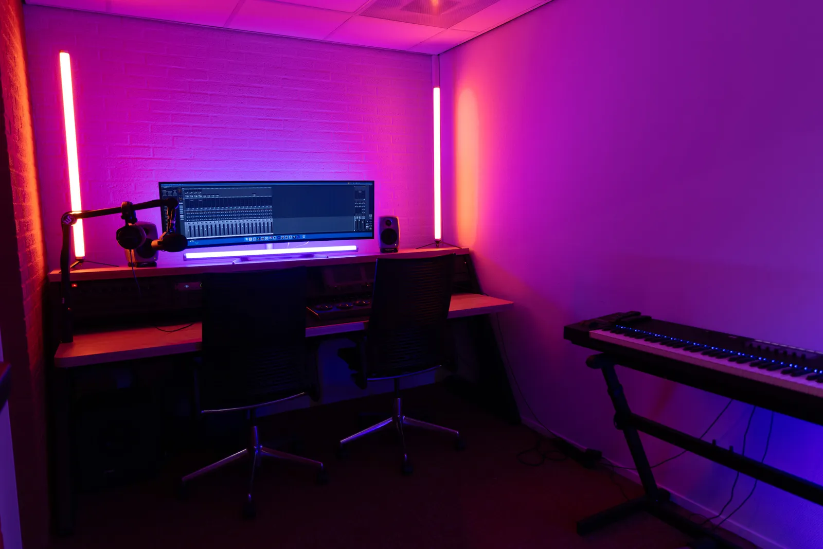 Edit bay desk setup, pink ambient lighting