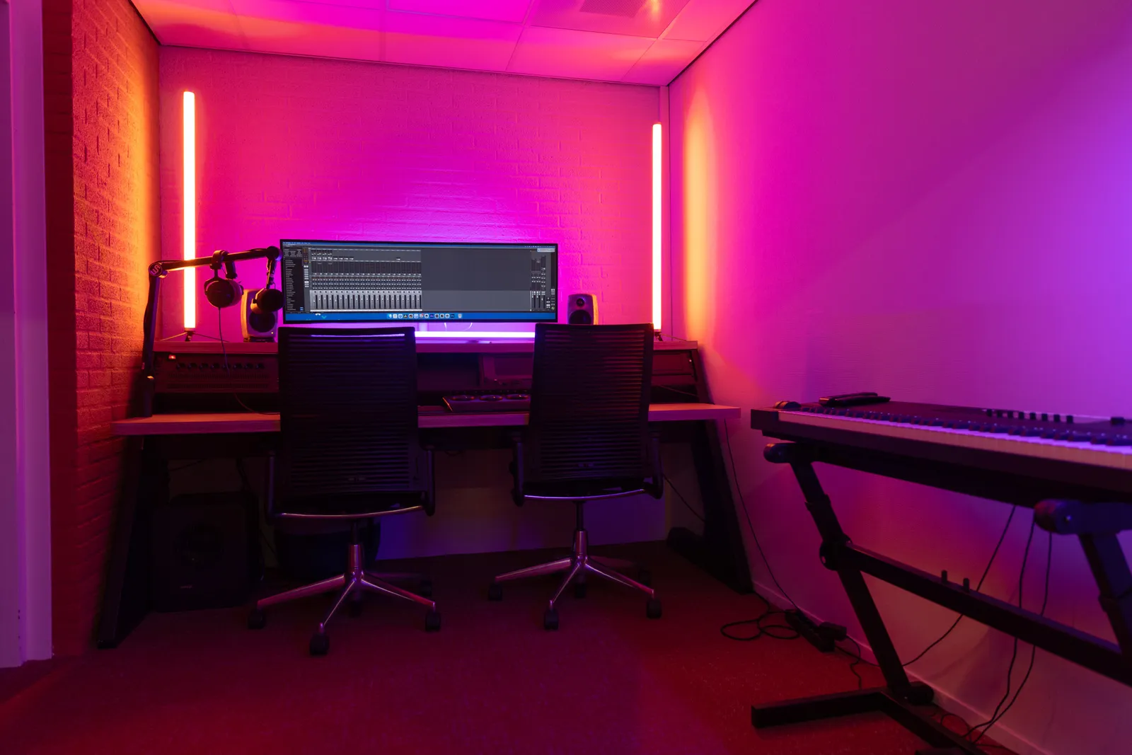 Edit bay desk with DAW mixer, red lighting