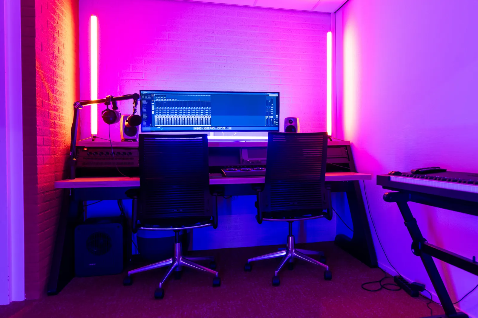 Edit bay desk and seating, pink lighting