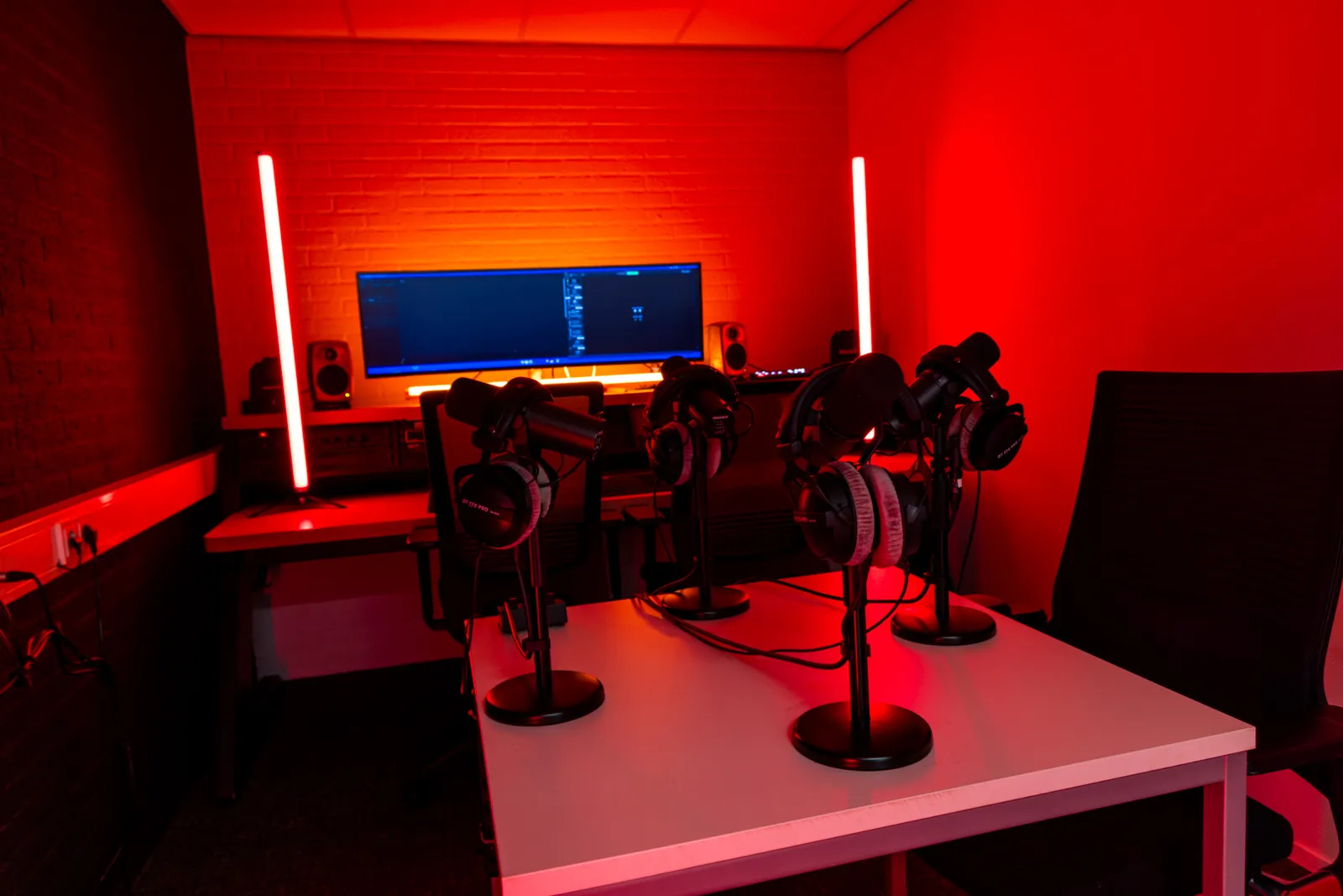 Podcast edit bay table with headphones and microphones