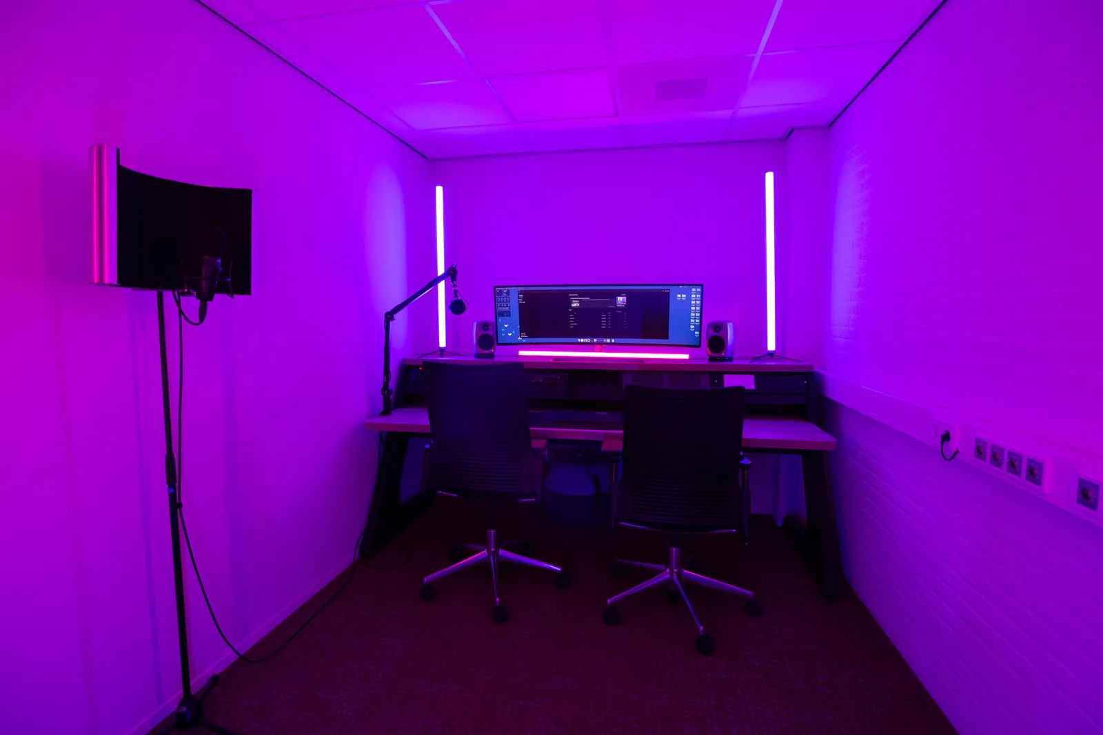 Podcast edit bay table, purple lighting