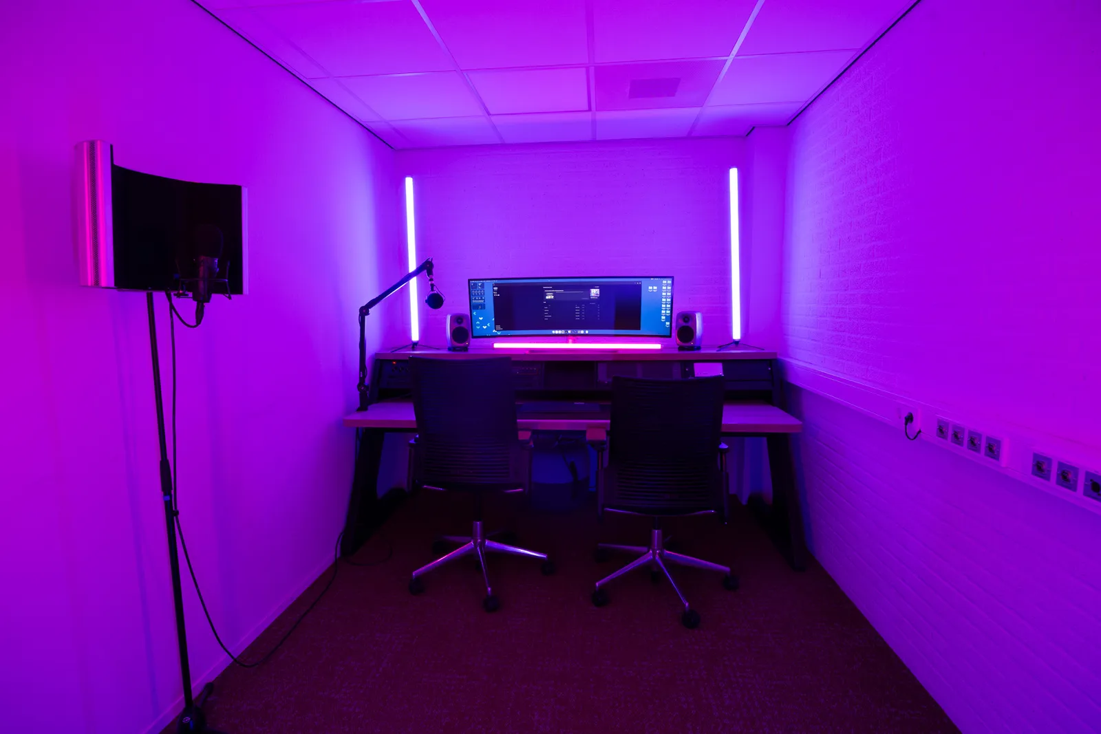 Podcast edit bay table, blue-green lighting